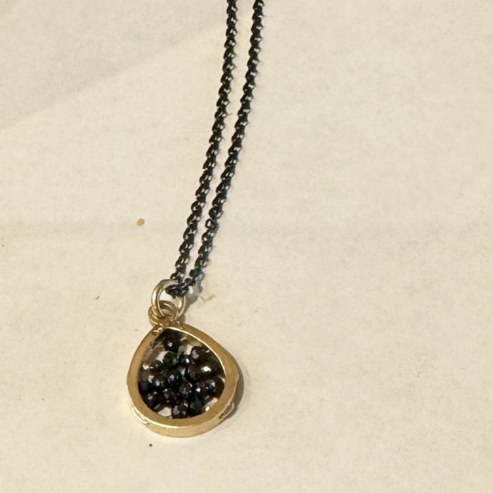 Reef pendant with tiny black diamond beads